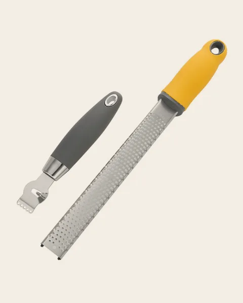 Fine rasp zester with a yellow handle beside a grey-handled channel knife
